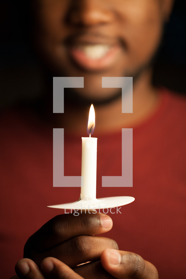 man holding a candle at a Christmas Eve Service 