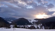 Winter hilly landscape at sunset, cloudy weather, timelapse
