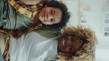 Portrait of Joyous African American Mom and Little Son Hugging on Couch at Home
