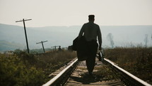 "A lonely man walking along railroad.
The clip can illustrate return home from war or prison.
Europe between 1940-1960."
