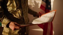 Military man in uniform read top secret documents