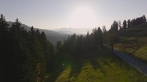 Aerial of forest, hills and mountains in sunset