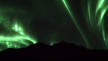 Green Aurora over mountains at night
