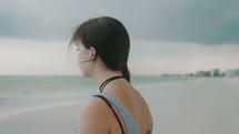 concerned girl standing on a beach 