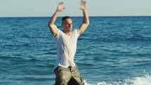 soldier does aerobic exercises on the seashore