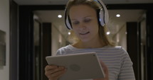 Timelapse of girl listening to music with tablet PC