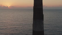 A lighthouse on the  Atlantic Ocean coast of South Carolina during sunrise 