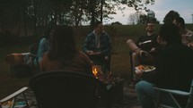 friends sitting around a fire 