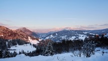 Winter mountain hilly landscape at dusk, blue sky, end of day