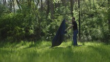 Young man reading his Bible outside on a warm sunny day