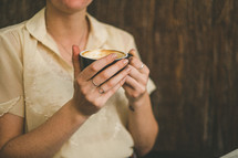 woman holding a cappuccino cup 