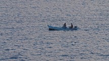 family in motor boat on the ocean at golden hour