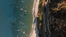Road And Cliff With Flat And Calm Ocean Water, Overhead Aerial