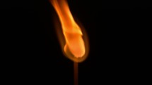 an igniting match on a black background.