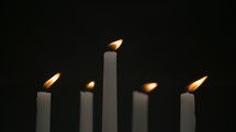 slow motion of flickering candles on a black background
