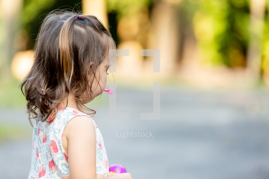 a toddler playing with bubbles 