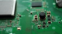 Circuit board with components. Extreme close up of green electronic board, with electronic components.
