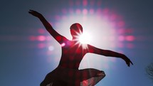 silhouette of a ballet dancer spinning 