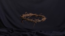falling crown of thorns on a purple sash