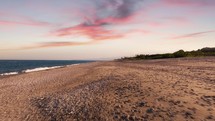 Sunset empty sandy beach near the ocean