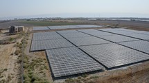 Sustainable energy solutions to global warming. Aerial shot of a solar power farm in a rural valley.