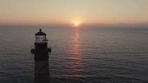 A lighthouse on the  Atlantic Ocean coast of South Carolina during sunrise 