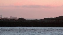 A Container Ship on a Pink Sky Going Into the Irish Sea Past Dalkey Island at Dawn