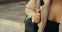 Young business woman walking around the city using her phone and laptop