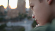 Young boy in thought in an urban setting