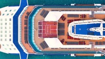 Aerial view of the cruise ship in open water. Passenger cruise ship sailing in ocean top view from above. Large luxury cruise liner deck. 