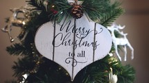 Merry Christmas sign moving on a Christmas Tree Cinemagraph