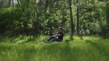 Young man reading his bible outside on a warm sunny day