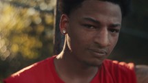 Portrait of a smiling young man playing basketball on a sunny day