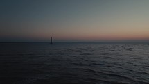 A lighthouse on the  Atlantic Ocean coast of South Carolina during sunrise 