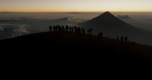 Silhouettes Of People On The Summit Of Acatenango Volcano During Dawn In Antigua, Guatemala. Aerial Drone Shot
