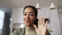 Screen headshot of smiling African American woman wave greet talk speak on video call.