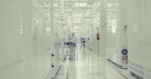 Workers in clean suits in a Semiconductor manufacturing facility