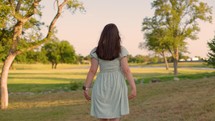 Girl Worshipping Outside at Sunset