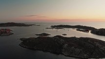 drone flies over Swedish archipelago at sunset in skarhamn