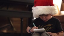 boy making a list for Santa 
