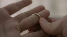 a man slipping off his wedding band 