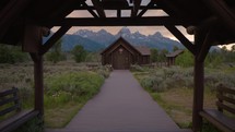 Old Wooden Chapel in the Mountains at Sunset