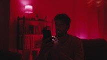 Man controlling the color of lights with phone 