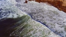 Waves approaching rocky coastline (slow motion)