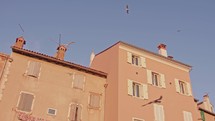old town facade with seagulls at golden hour by the ocean