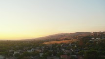 neighborhoods in a valley at sunset 