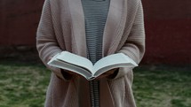 close up of a woman closing a Bible 