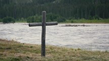 Old Wooden Cross Next To A River	