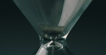 sand moving through an hourglass 