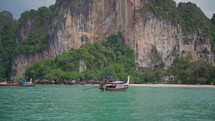 boat pulls past thailand scenery